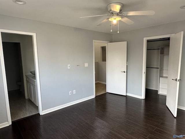 unfurnished bedroom featuring a closet, baseboards, and dark wood-type flooring