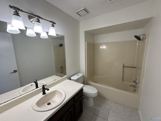 bathroom with toilet, washtub / shower combination, a textured ceiling, vanity, and tile patterned flooring