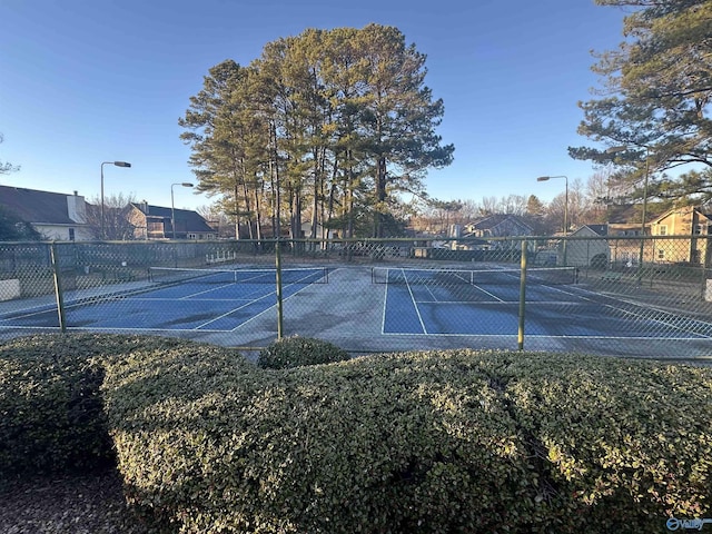 view of sport court featuring fence