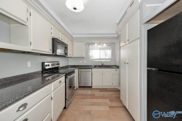 kitchen featuring white cabinetry, sink, dark stone countertops, black appliances, and ornamental molding