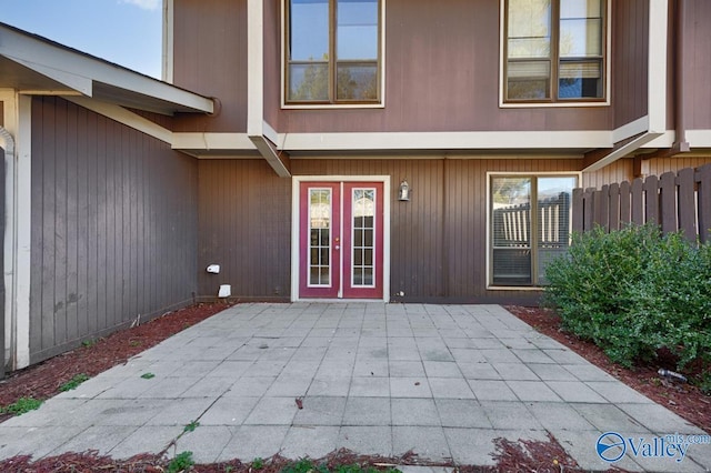 property entrance featuring a patio area and french doors