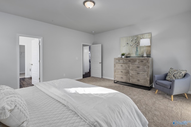 bedroom featuring baseboards and carpet flooring