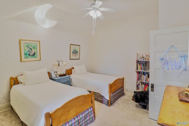 bedroom with light colored carpet, a ceiling fan, and baseboards