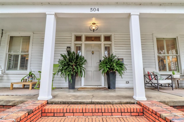 view of exterior entry with covered porch