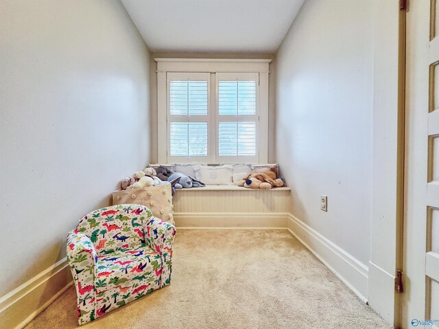 unfurnished room featuring carpet and baseboards