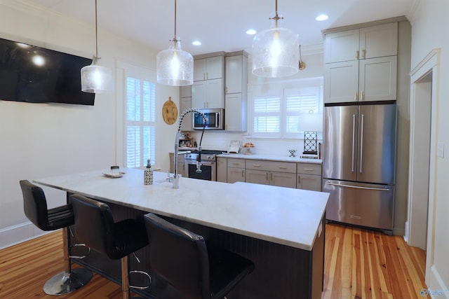 kitchen featuring light countertops, recessed lighting, stainless steel appliances, and light wood-type flooring