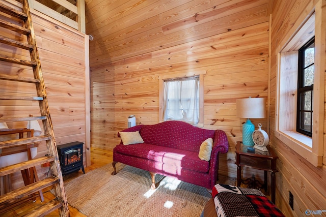 living room featuring wood walls and a wood stove