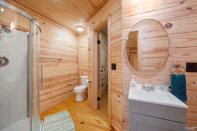 bathroom with wooden walls, vanity, wooden ceiling, and toilet