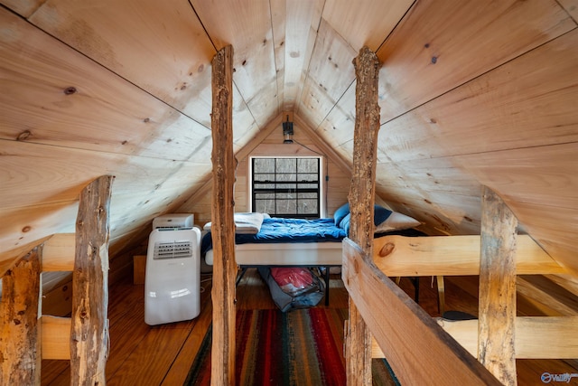 additional living space with wood walls, wooden ceiling, and vaulted ceiling