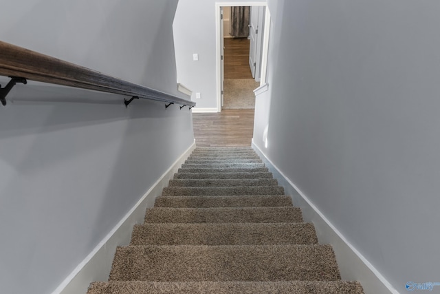 stairs with hardwood / wood-style floors