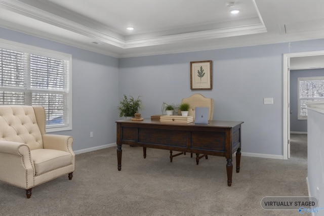 home office with crown molding, light carpet, and a tray ceiling