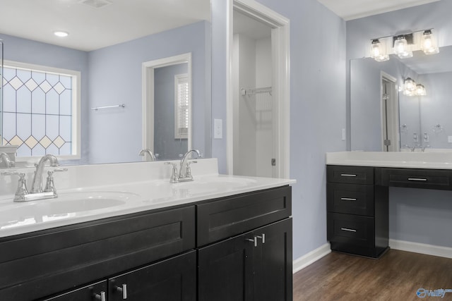 bathroom with hardwood / wood-style floors, vanity, and a wealth of natural light