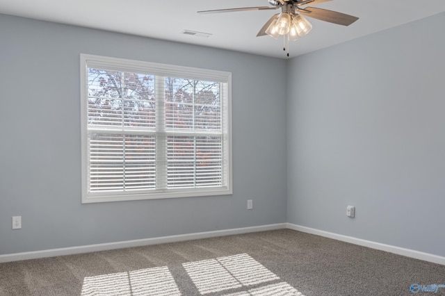 carpeted spare room with ceiling fan