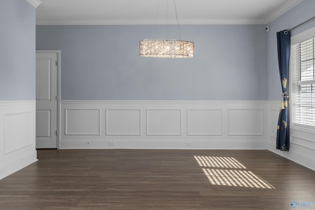 unfurnished room with ornamental molding, dark hardwood / wood-style flooring, a healthy amount of sunlight, and a notable chandelier