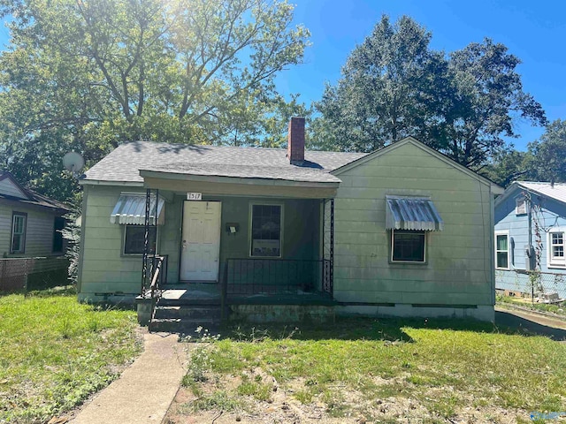 bungalow with a front yard and a porch