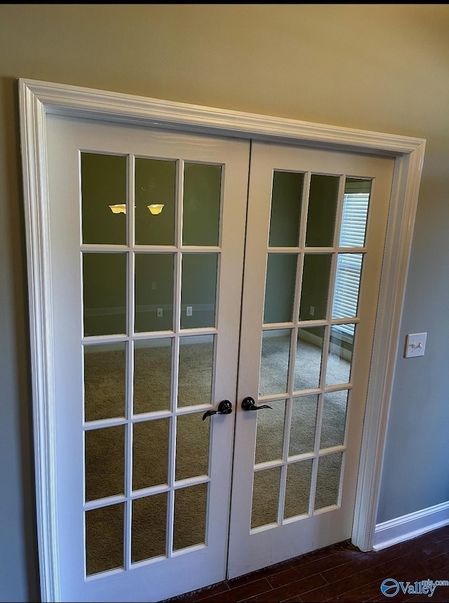 entryway with dark hardwood / wood-style flooring and french doors