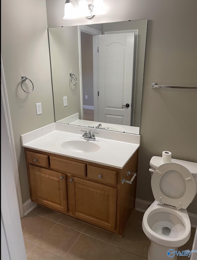 bathroom featuring vanity, tile patterned floors, and toilet