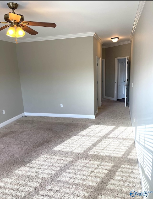 carpeted empty room featuring ornamental molding and ceiling fan