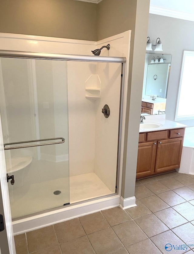 bathroom featuring walk in shower, tile patterned floors, vanity, and crown molding