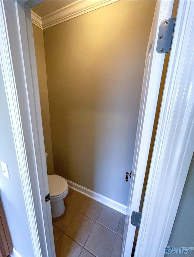 bathroom with ornamental molding, tile patterned floors, and toilet