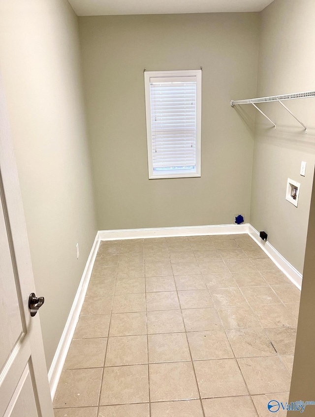 laundry area featuring hookup for a washing machine and light tile patterned floors