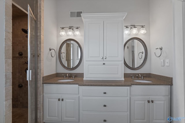 bathroom featuring vanity and tiled shower