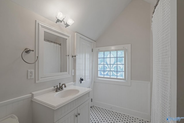 bathroom with vanity, a shower with curtain, toilet, and vaulted ceiling