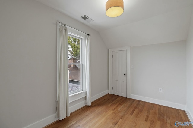 bonus room featuring lofted ceiling and light hardwood / wood-style floors