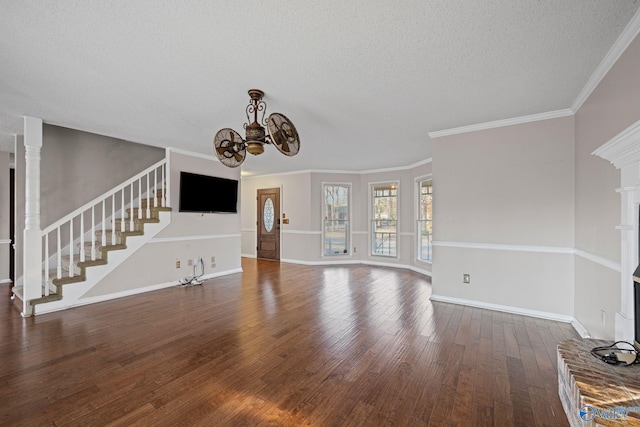 unfurnished living room with a textured ceiling, a brick fireplace, dark hardwood / wood-style flooring, and ornamental molding