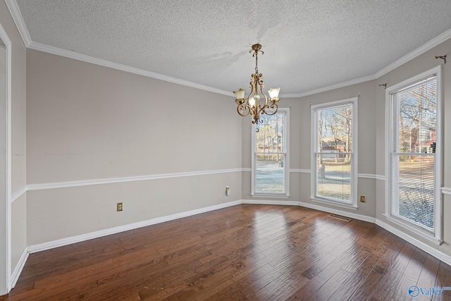 unfurnished dining area with a textured ceiling, an inviting chandelier, ornamental molding, and dark hardwood / wood-style floors