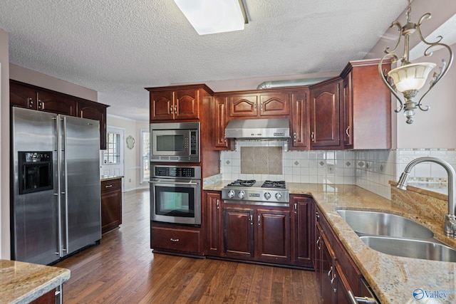 kitchen featuring a textured ceiling, appliances with stainless steel finishes, dark hardwood / wood-style flooring, tasteful backsplash, and sink