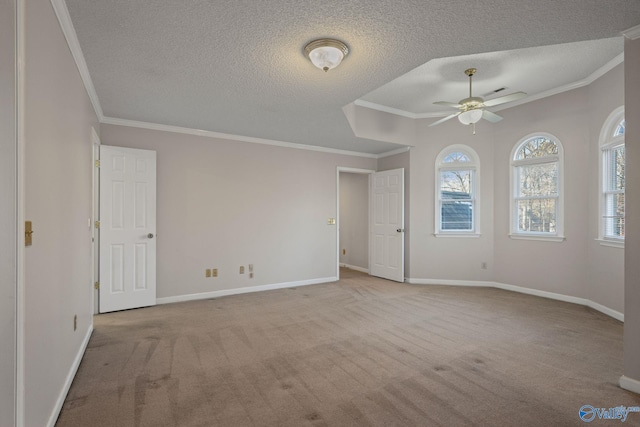 carpeted empty room with ceiling fan, crown molding, and a textured ceiling