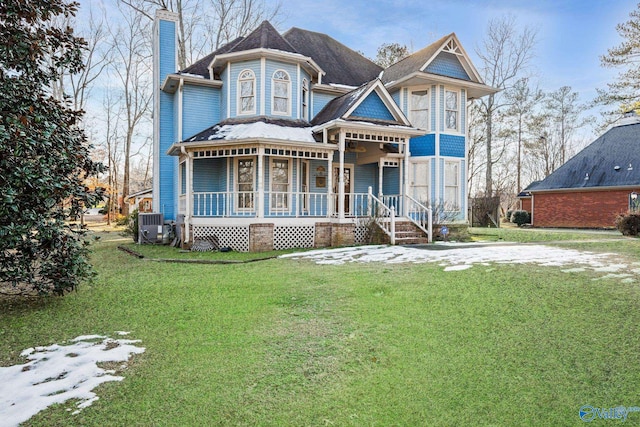 victorian home featuring a front lawn and a porch