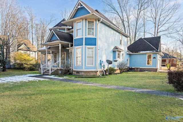 victorian home featuring a front lawn and a porch