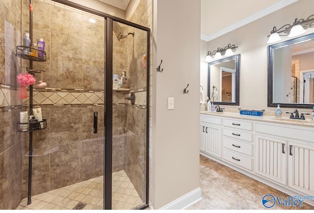 full bathroom with double vanity, a stall shower, crown molding, and a sink