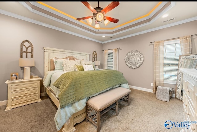 bedroom with visible vents, baseboards, crown molding, carpet flooring, and a raised ceiling