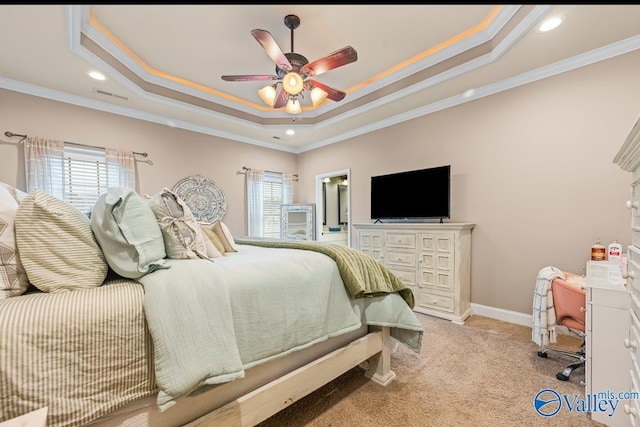 bedroom featuring a tray ceiling, multiple windows, visible vents, and light carpet