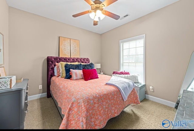 carpeted bedroom featuring visible vents, baseboards, and ceiling fan