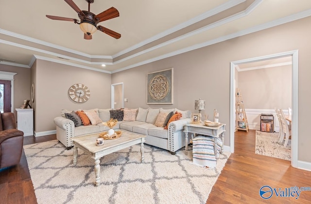 living room featuring a ceiling fan, wood finished floors, and baseboards