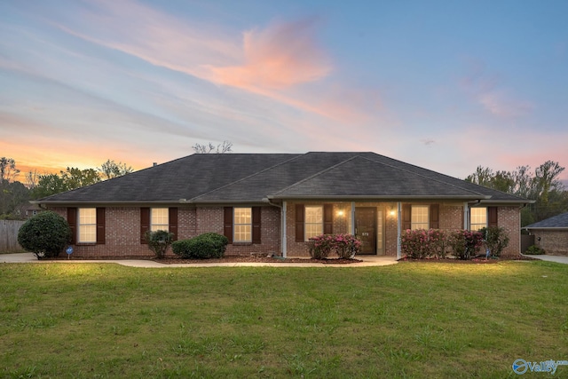 ranch-style home with a yard