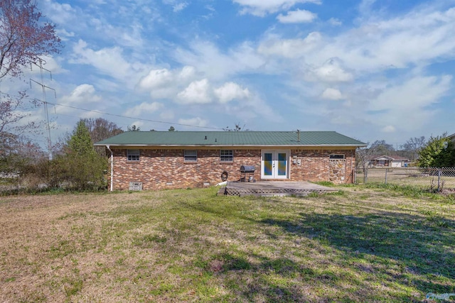 back of house with a lawn, a patio, fence, french doors, and brick siding