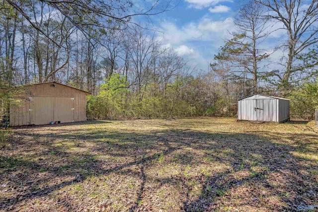view of yard featuring an outbuilding and a shed