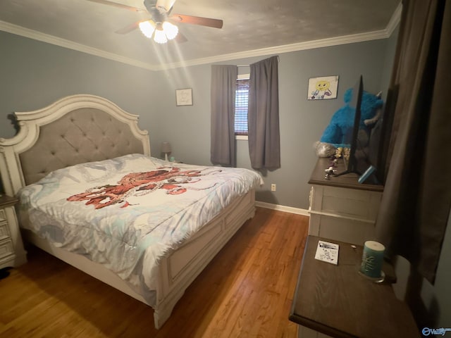 bedroom with ornamental molding, ceiling fan, baseboards, and wood finished floors