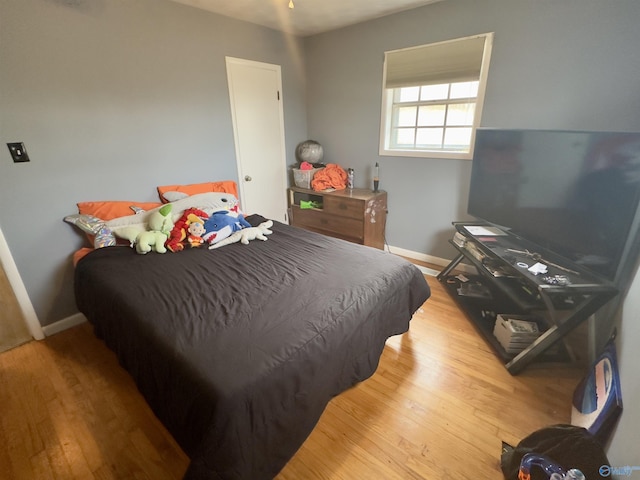 bedroom featuring wood finished floors and baseboards