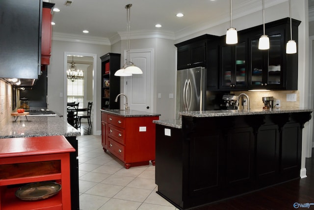 6901 Ridge Pointe Dr SE, Owens Cross Roads, AL 35763 - kitchen featuring stainless steel refrigerator, a peninsula, tasteful backsplash, a sink, and light stone countertops