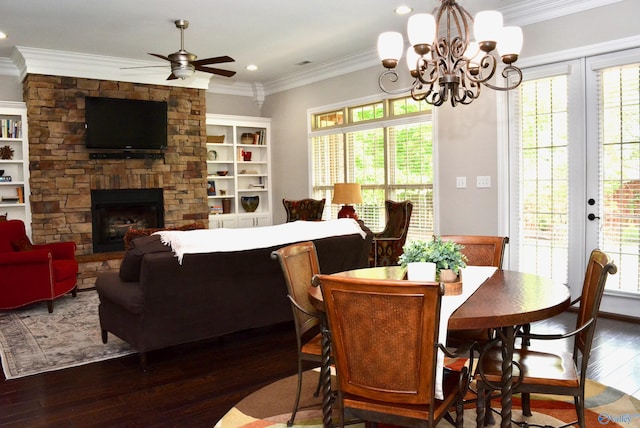 6901 Ridge Pointe Dr SE, Owens Cross Roads, AL 35763 - dining space with dark wood-style floors, crown molding, a stone fireplace, a chandelier, and ceiling fan