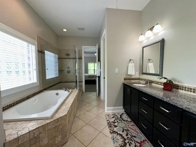 6901 Ridge Pointe Dr SE, Owens Cross Roads, AL 35763 - full bathroom with a garden tub, double vanity, a stall shower, tile patterned flooring, and baseboards