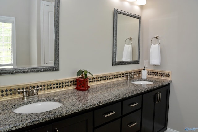 6901 Ridge Pointe Dr SE, Owens Cross Roads, AL 35763 - bathroom featuring double vanity and tasteful backsplash