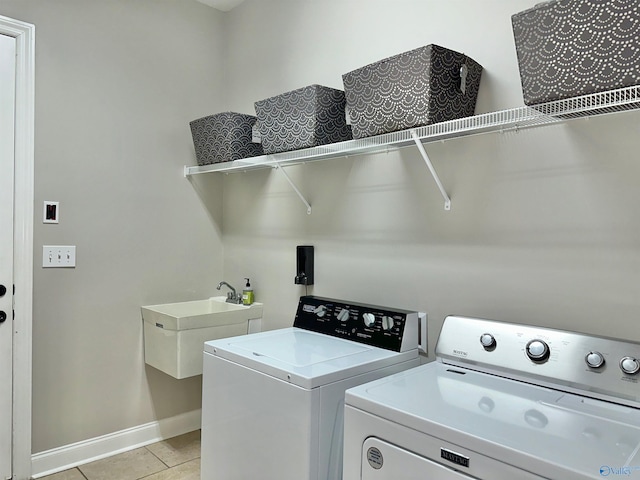 6901 Ridge Pointe Dr SE, Owens Cross Roads, AL 35763 - washroom featuring washing machine and clothes dryer, baseboards, and light tile patterned floors