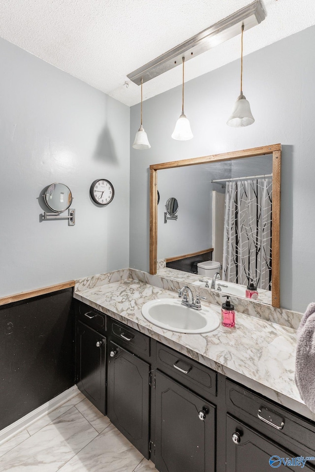 bathroom featuring walk in shower, toilet, a textured ceiling, and vanity